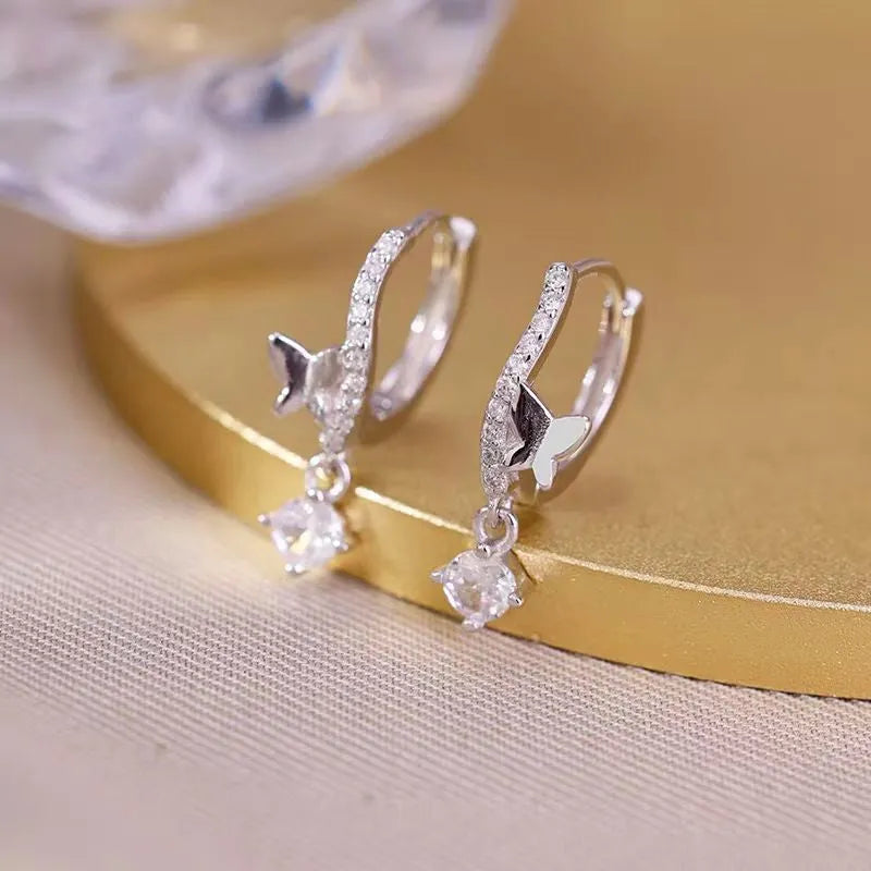 Model showcasing the dangle and style of the Sterling Silver Zircon Butterfly Earrings