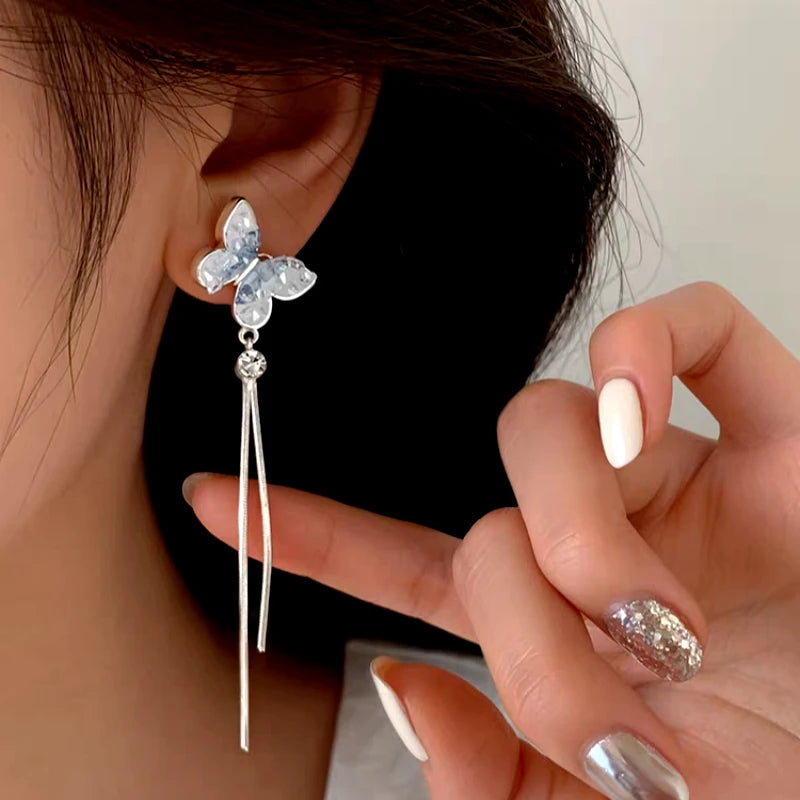 Angled view of the Sterling Silver Zircon Butterfly Tassel Earrings