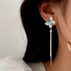 Model showcasing the dangle and style of the Sterling Silver Zircon Butterfly Tassel Earrings