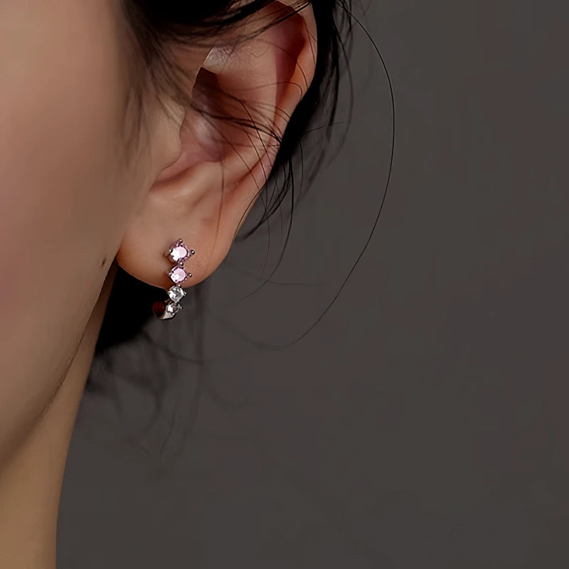 Model showcasing the dangle and style of the Sterling Silver Zircon C-Shaped Earrings