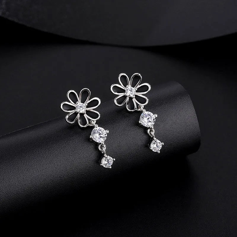 Close-up detail of the sparkling zircons and plating on the Daisy Dangle Earrings