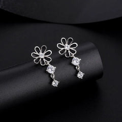 Close-up detail of the sparkling zircons and plating on the Daisy Dangle Earrings
