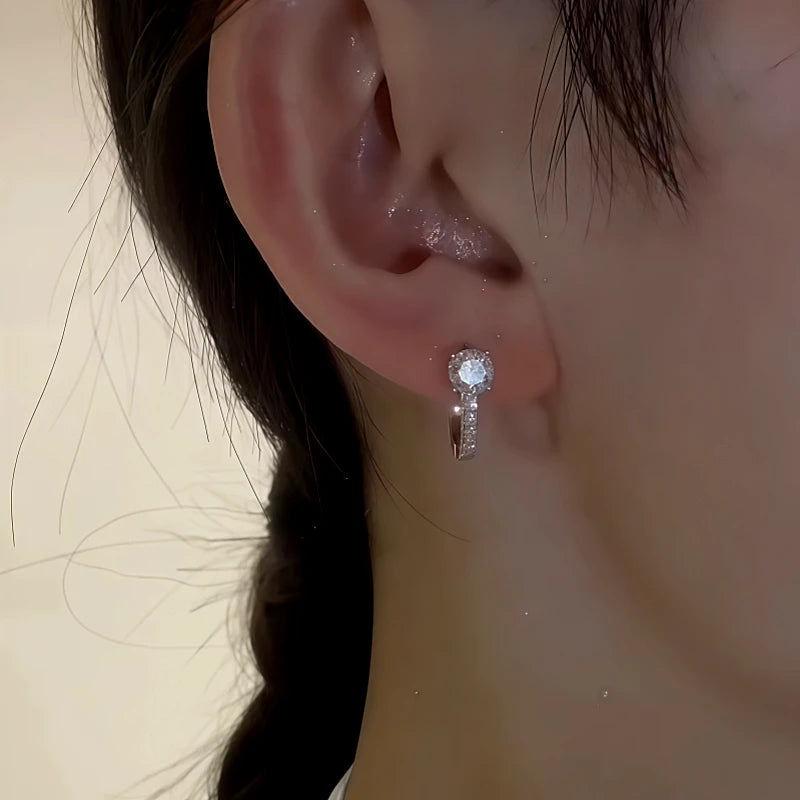 Model showcasing the dangle and style of the Sterling Silver Zircon Diamond Earrings