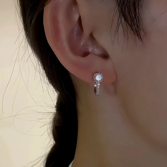 Model showcasing the dangle and style of the Sterling Silver Zircon Diamond Earrings