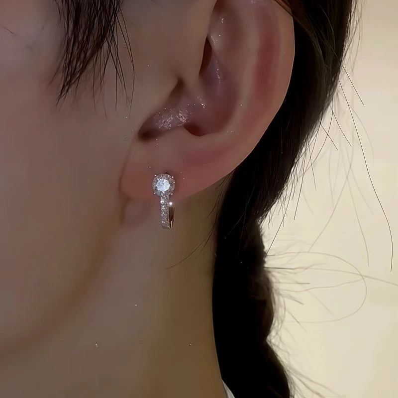 Close-up detail of the sparkling zircons and plating on the Zircon Huggie Hoops