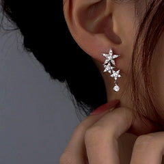 Model showcasing the dangle and style of the Sterling Silver Zircon Five-Pointed Star Earrings
