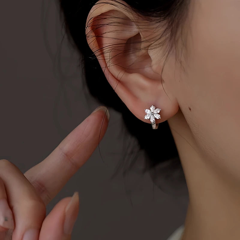 Model showcasing the dangle and style of the Sterling Silver Zircon Flower Hoop Earrings