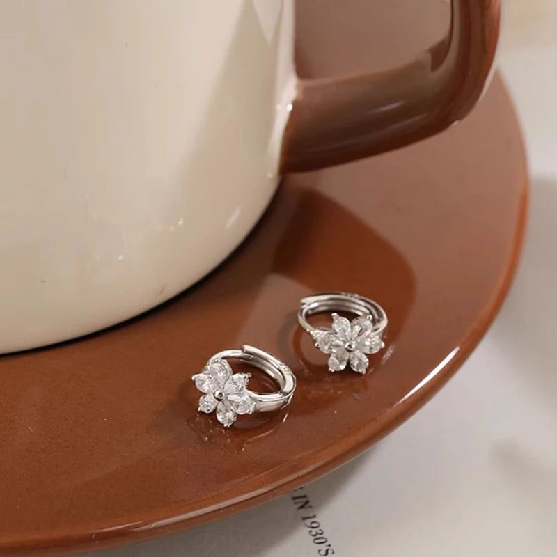 Angled view of the Sterling Silver Zircon Flower Hoop Earrings