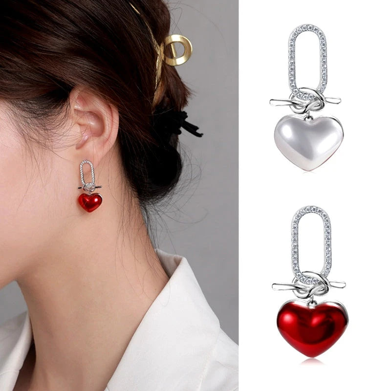 Close-up detail of the sparkling zircons and plating on the Red Heart Dangle Earrings
