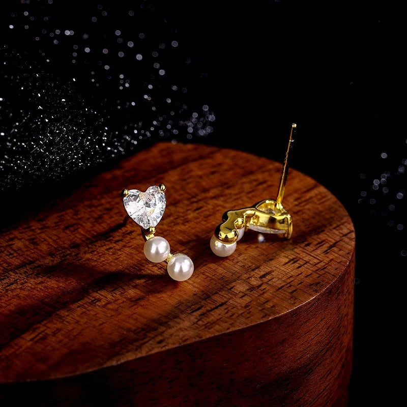 Close-up detail of the sparkling zircons and plating on the Heart Pearl Studs