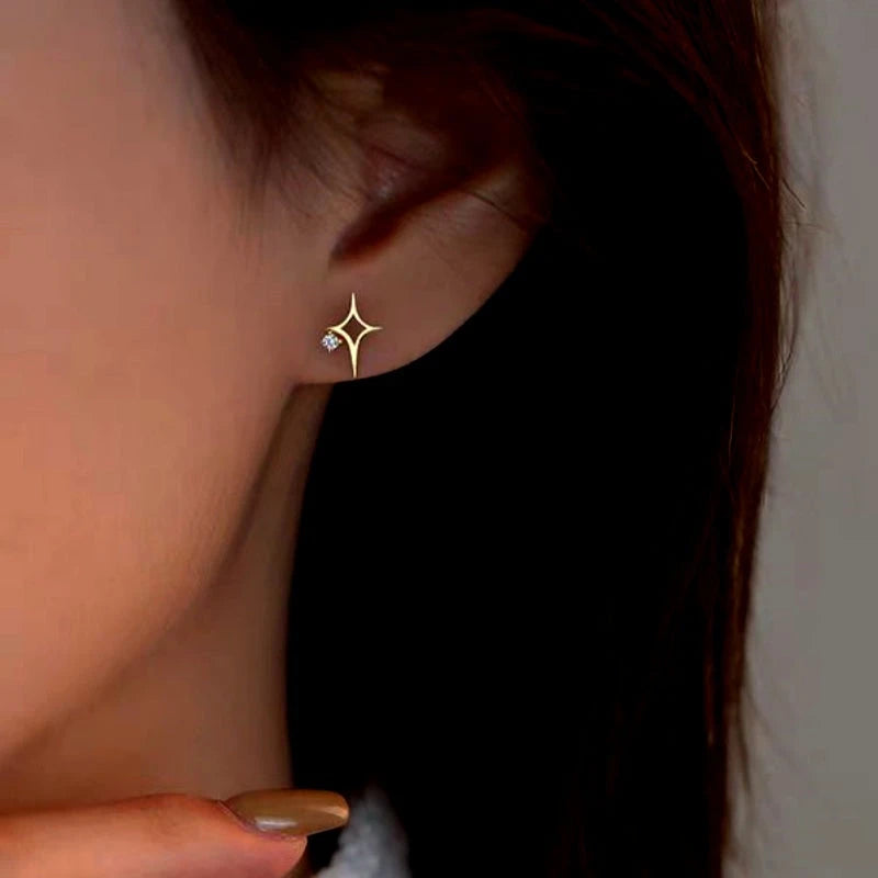 Model showcasing the dangle and style of the Sterling Silver Zircon Hollow Four-Cornered Star Stud Earrings