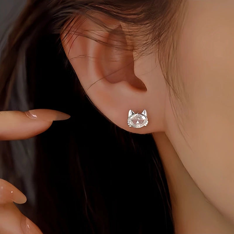 Model showcasing the dangle and style of the Sterling Silver Zircon Kitten Stud Earrings
