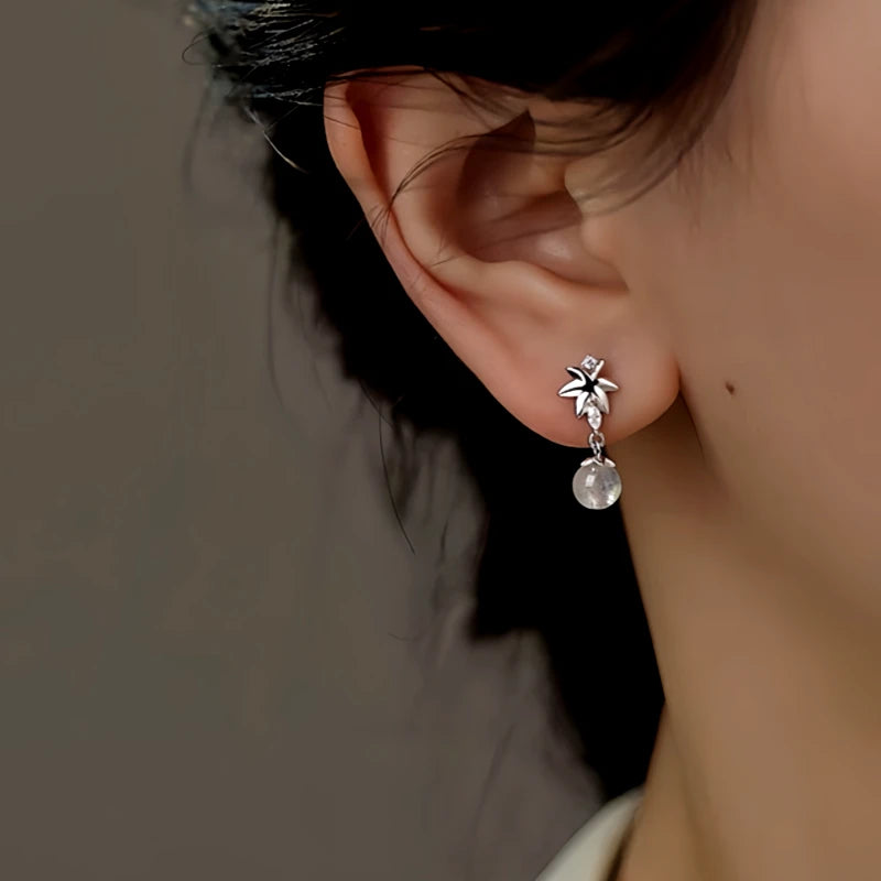 Close-up detail of the sparkling zircons and plating on the Maple Leaf Earrings