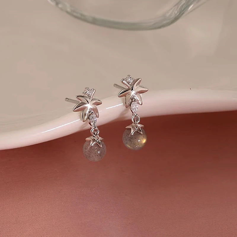 Angled view of the Sterling Silver Zircon Maple Leaf Earrings