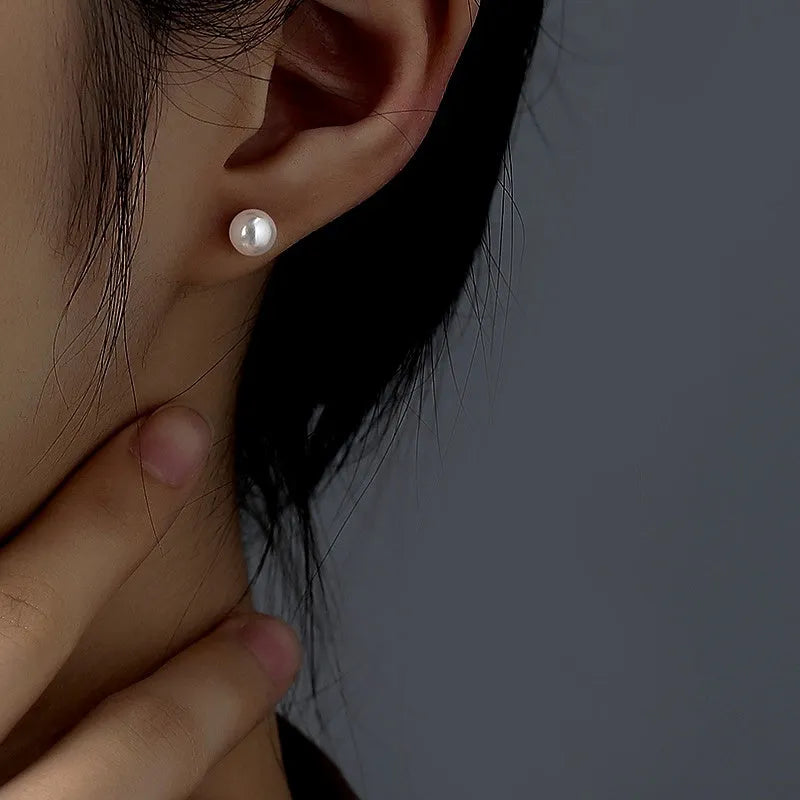 Model showcasing the dangle and style of the Sterling Silver Zircon Pearl Asymmetrical Earrings