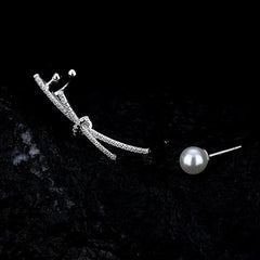 Close-up detail of the sparkling zircons and plating on the Asymmetrical Pearl Earrings