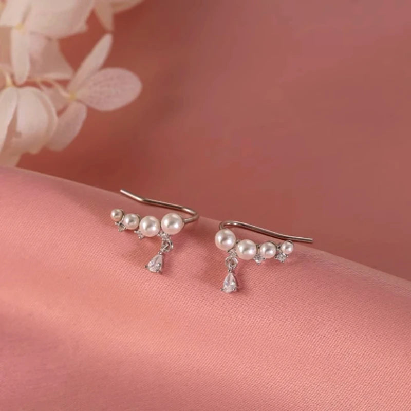 Angled view of the Sterling Silver Zircon Pearl Crawler Earrings