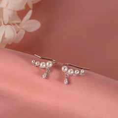 Angled view of the Sterling Silver Zircon Pearl Crawler Earrings
