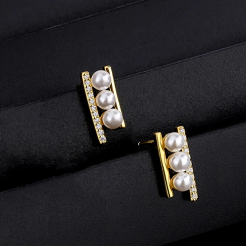 Angled view of the Sterling Silver Zircon Pearl Stud Earrings