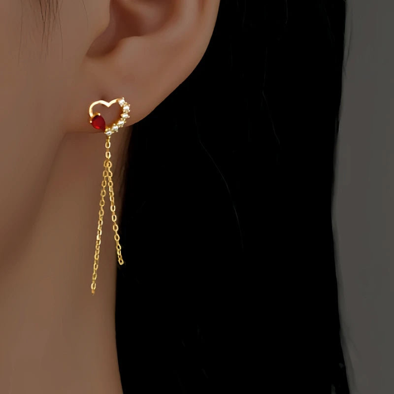 Angled view of the Sterling Silver Zircon Red Diamond Heart Tassel Earrings
