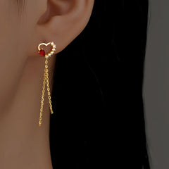 Angled view of the Sterling Silver Zircon Red Diamond Heart Tassel Earrings