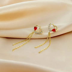 Model showcasing the dangle and style of the Sterling Silver Zircon Red Diamond Heart Tassel Earrings