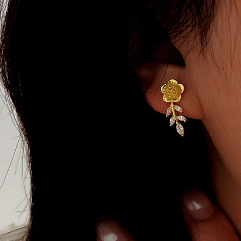 Model showcasing the dangle and style of the Sterling Silver Zircon Small Fragrance Style Flower Earrings