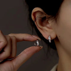Close-up detail of the sparkling zircons and plating on the Sun Hoop Earrings