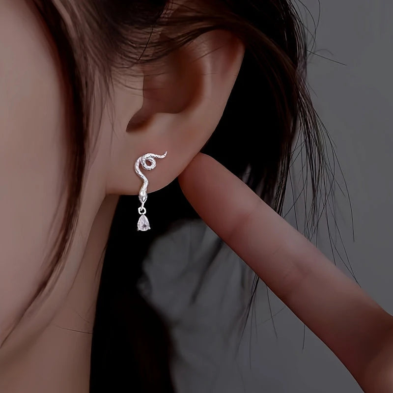 Model showcasing the dangle and style of the Sterling Silver Zircon Snake Earrings