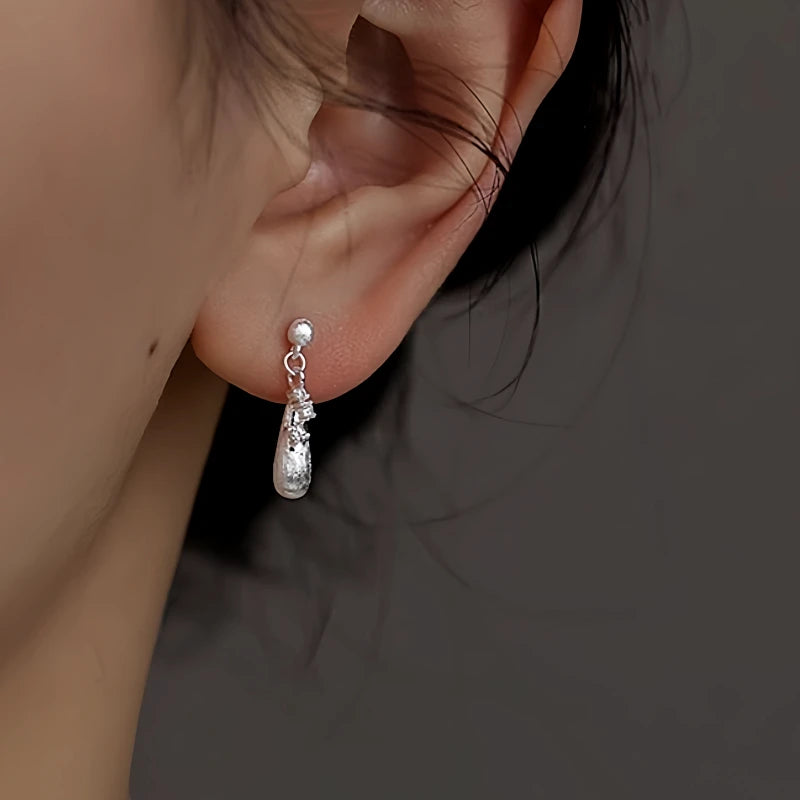 Close-up detail of the sparkling zircons and plating on the Water Drop Earrings