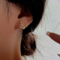Model showcasing the dangle and style of the Sterling Silver Zircon Wheat Stud Earrings