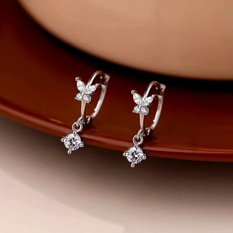 Model showcasing the dangle and style of the Sterling Silver uper Fairy Zircon Butterfly Earrings
