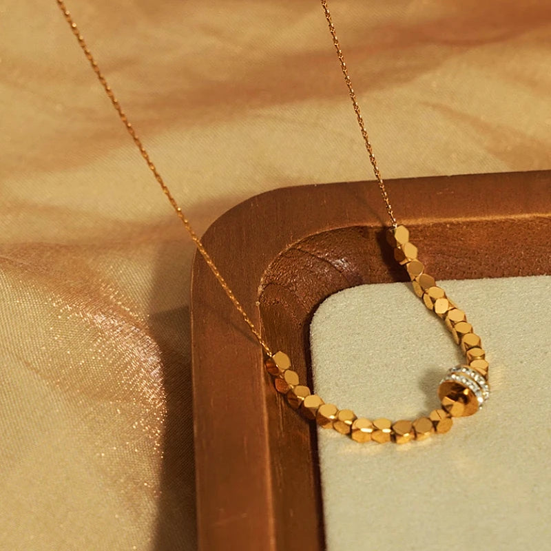 Detailed view of the 14K Gold-Plated Sugar Cube Ring Necklace chain and pendant