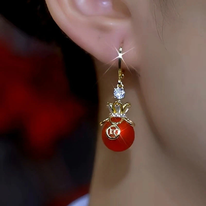 Close-up detail of the sparkling zircons and plating on the Red Money Bag Earrings