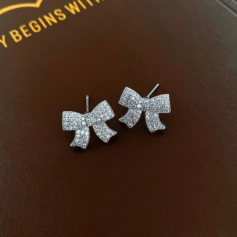 Angled view of the 14K Gold-Plated Elegant Zircon Diamond Butterfly And Bow Earrings