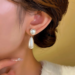 Model showcasing the dangle and style of the 14K Gold-Plated Pear Water Drop Earrings