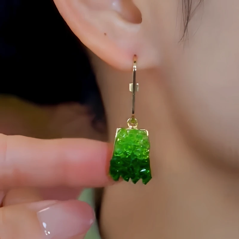 Close-up detail of the sparkling zircons and plating on the Green Crystal Earrings