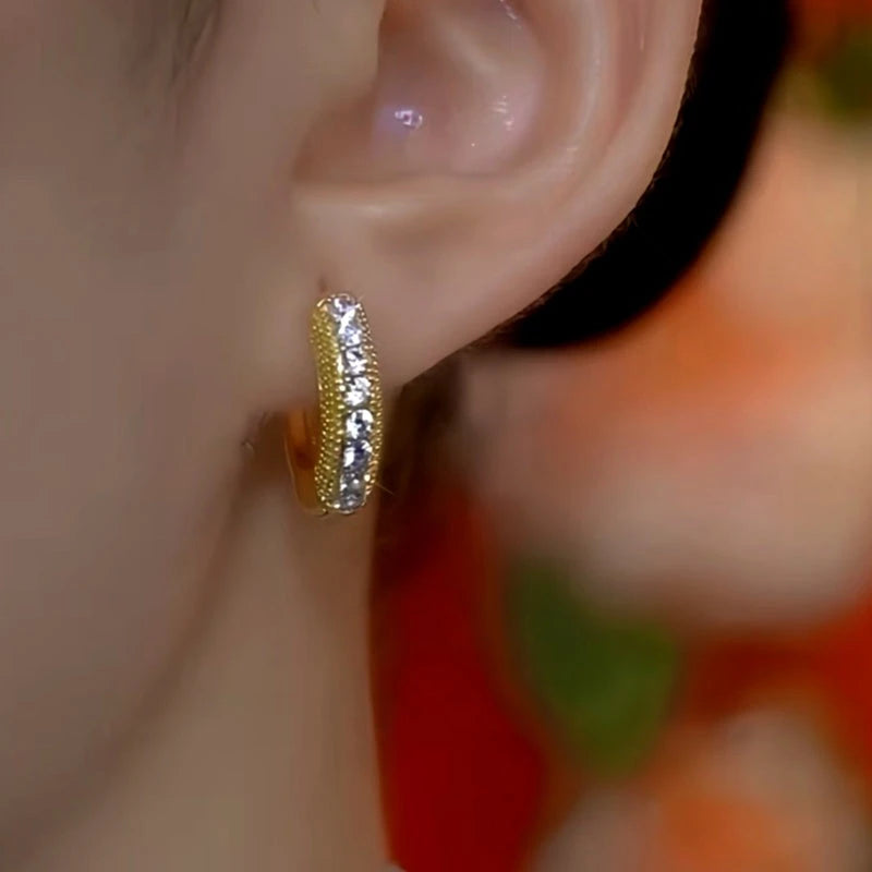 Model showcasing the dangle and style of the 14K Gold-Plated Exquisite Zircon Hoop Earrings