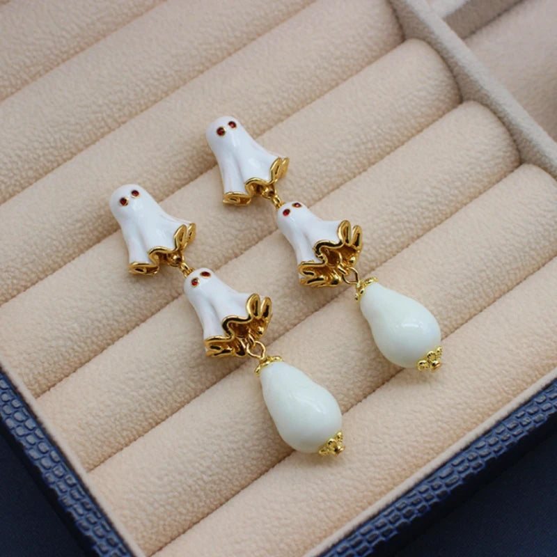 Angled view of the Halloween 14K Gold-Plated White Ghost Earrings