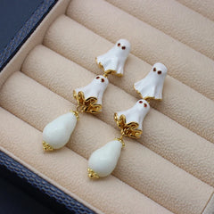 Model showcasing the dangle and style of the Halloween 14K Gold-Plated White Ghost Earrings