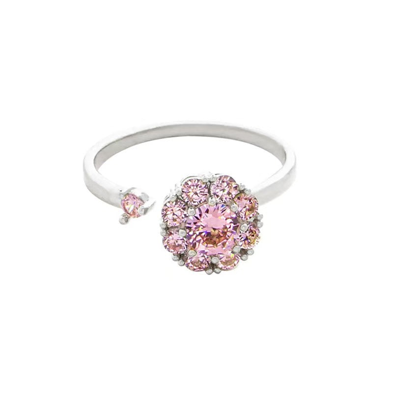 Silver adjustable pink crystal cluster flower ring on white background