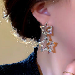 Close-up detail of the sparkling zircons and plating on the Star Dangle Earrings