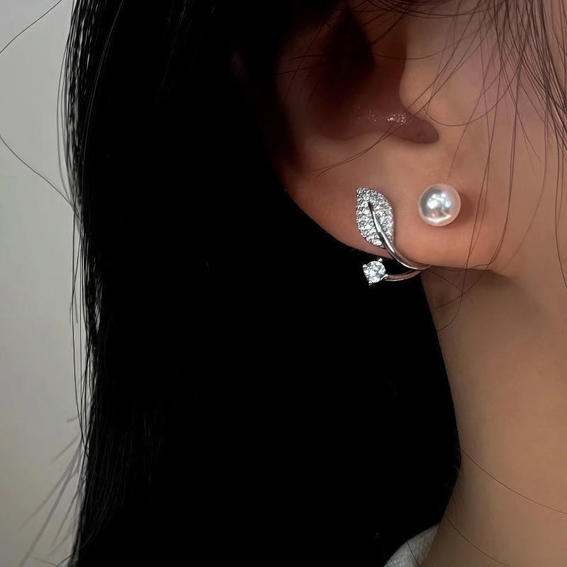 Model showcasing the dangle and style of the 14K Gold-Plated Elegant Zircon Diamond Leaf Jacket Earrings