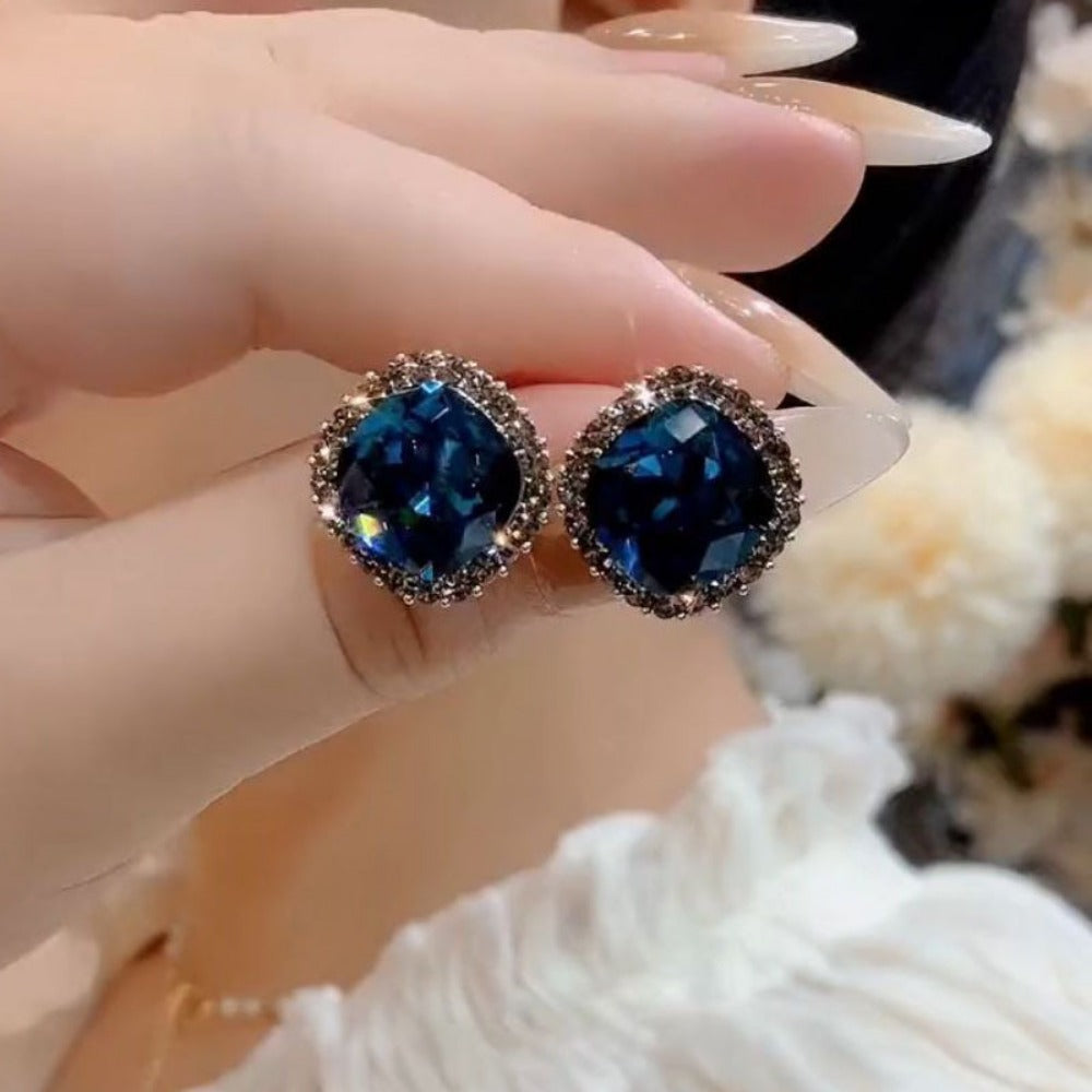 Vintage dark blue cushion cut crystal stud earrings held on hand