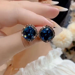 Vintage dark blue cushion cut crystal stud earrings held on hand