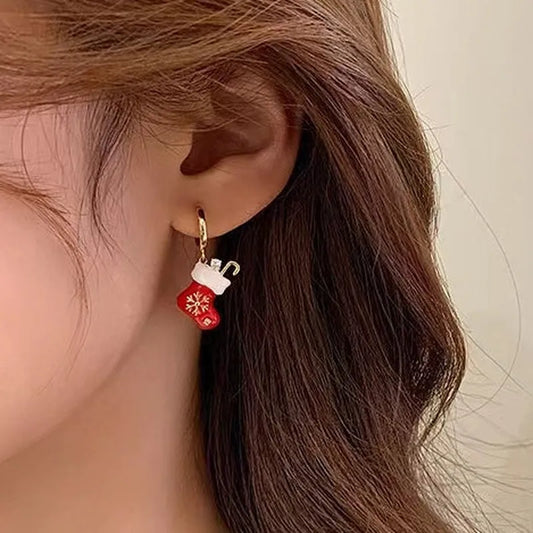 Model showcasing the dangle and style of the 14K Gold Plated Christmas Socks Earrings