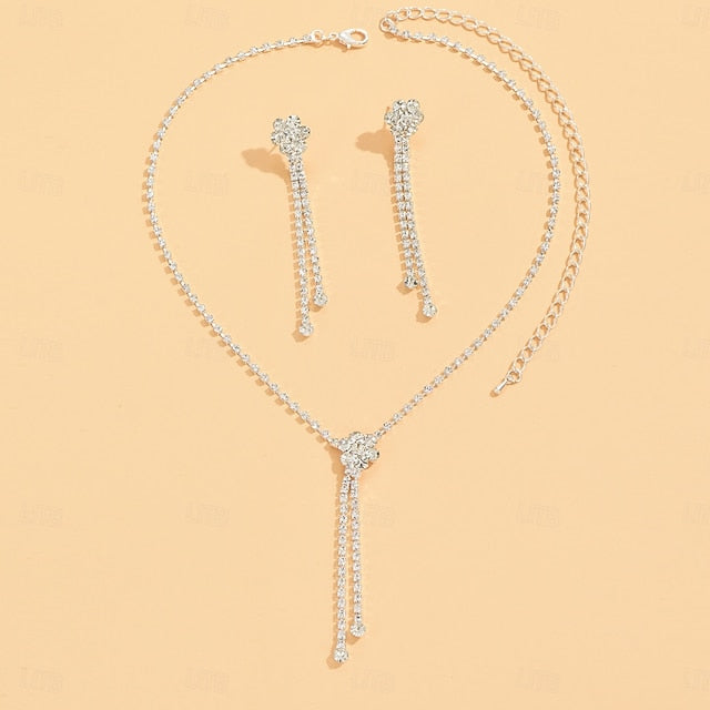 Silver pave rhinestone Y-tassel necklace and matching drop earring set on peach background