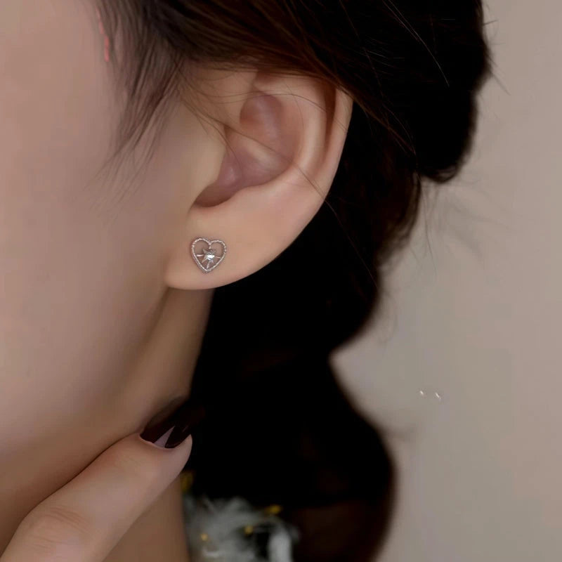Model showcasing the dangle and style of the Sterling Silver Elegant Zircon Diamond Heart Studs